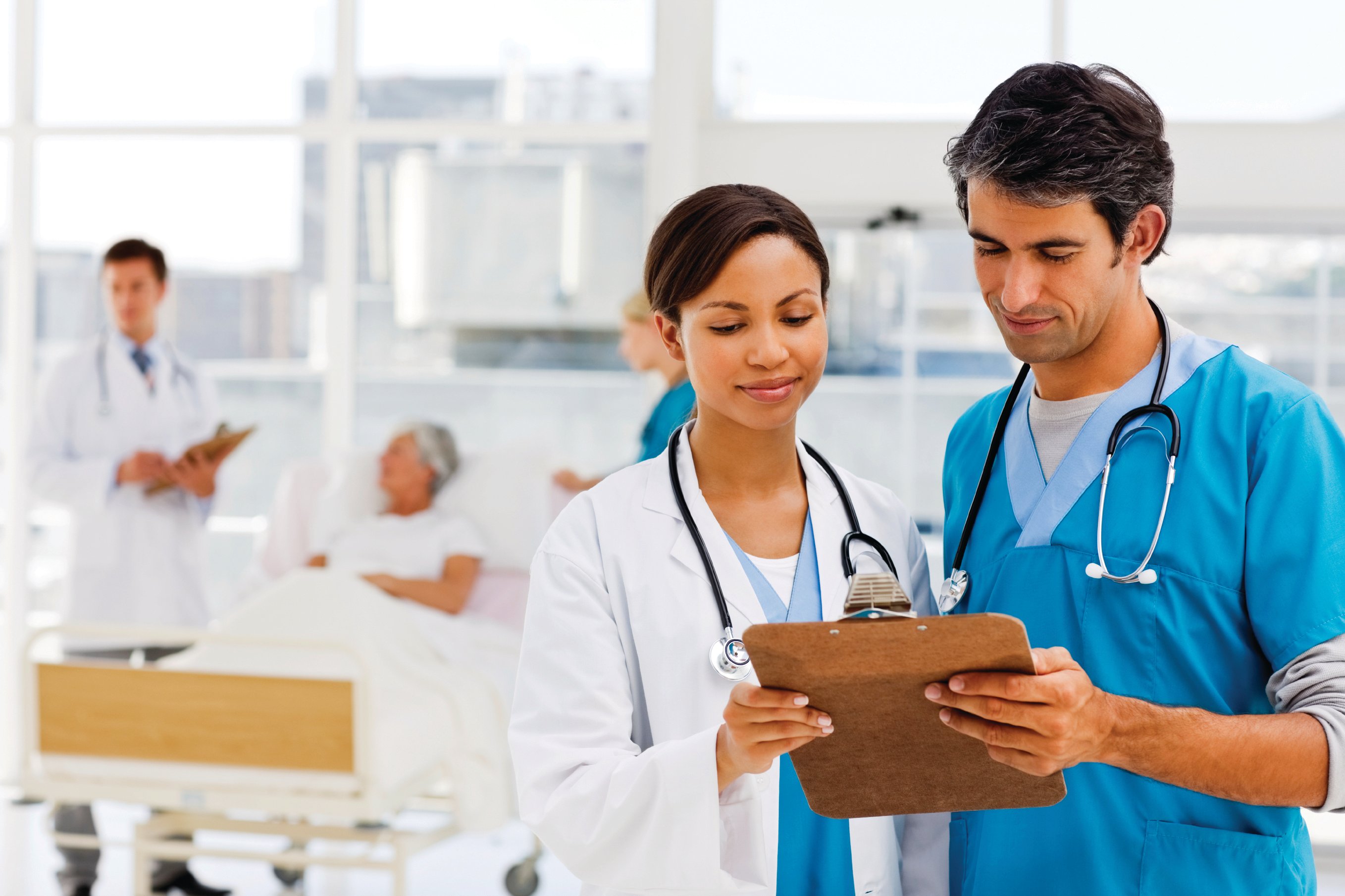 Two hospitalists look over a clipboard